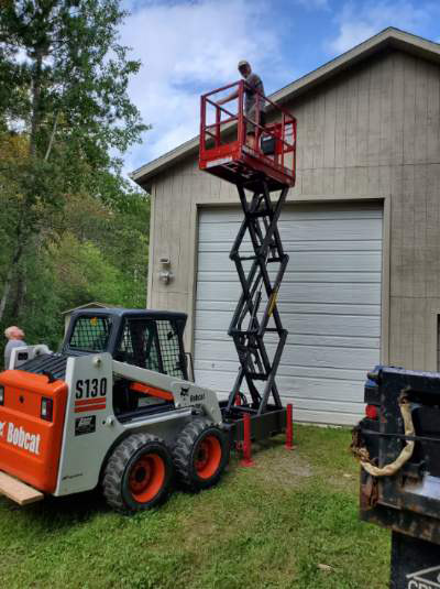 Staining a Building with the Skid-Lift