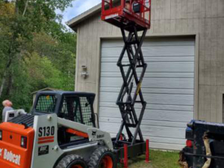 Staining a Building with the Skid-Lift Staining a Building with the Skid-Lift